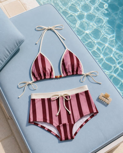 Coast Tempo Berry Stripe Bikini Set arranged poolside beside clear blue water