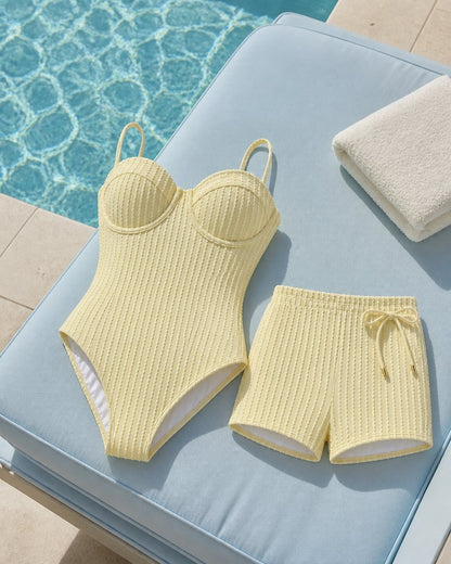 Coast Tempo Butter Club Stripe Set arranged poolside beside clear blue water