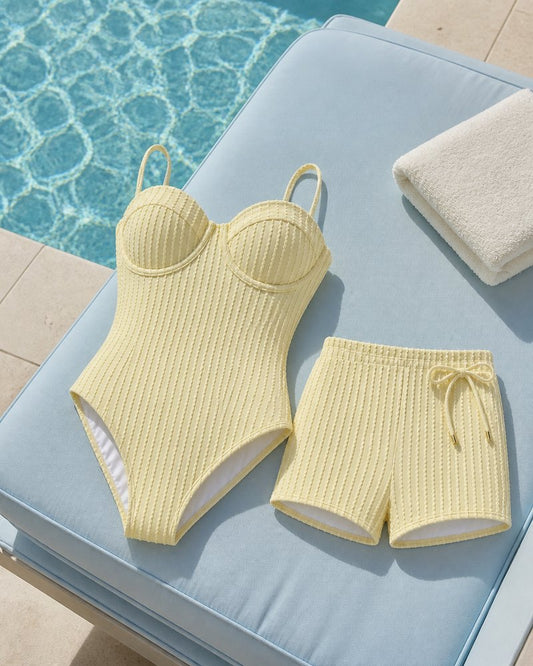 Coast Tempo Butter Club Stripe Set arranged poolside beside clear blue water